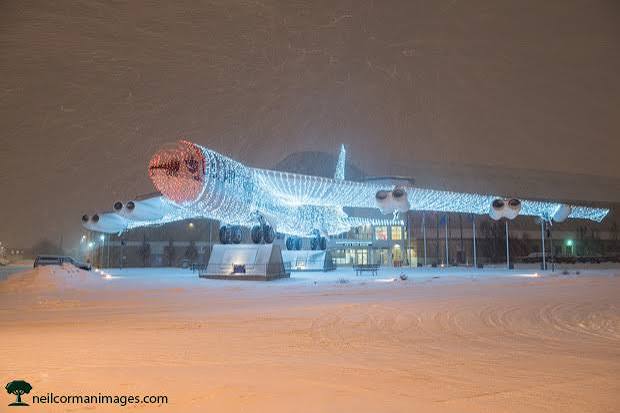 Front view of the real B-52 bomber with its red-tipped nose covered in Christmas lights