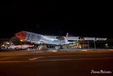 Full side view of the illuminated B-52 bomber at night